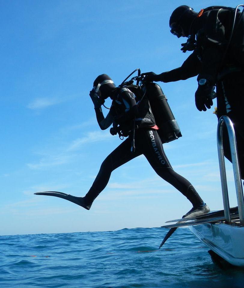 diver taking a giant stride into the water just like our students do when starting a new career with miltiary benefits